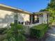 Charming patio area perfect for outdoor dining with manicured hedges and attractive landscaping at 8130 Bugle Ct # 3, Port Richey, FL 34668