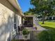 Quaint outdoor patio with seating area, surrounded by beautiful landscaping and view of the lush green lawn at 8130 Bugle Ct # 3, Port Richey, FL 34668