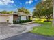 Well-maintained home featuring a large driveway, landscaping and lawn at 8130 Bugle Ct # 3, Port Richey, FL 34668