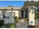 Inviting front entrance with security system, decorative plants, and outdoor seating at 8130 Bugle Ct # 3, Port Richey, FL 34668