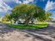 This property features a single-story home surrounded by mature trees and landscaping, situated on a corner lot at 8130 Bugle Ct # 3, Port Richey, FL 34668