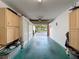 Garage featuring ample storage space, built-in cabinets, and updated flooring at 8130 Bugle Ct # 3, Port Richey, FL 34668