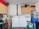 Functional garage with washer, dryer hookups, and cabinet storage at 8130 Bugle Ct # 3, Port Richey, FL 34668