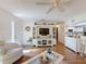 Cozy living room featuring a large built-in entertainment center, hardwood floors, and a comfortable armchair at 8130 Bugle Ct # 3, Port Richey, FL 34668