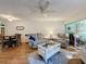 Open-concept living room connected to dining area and sunroom, with comfortable furniture at 8130 Bugle Ct # 3, Port Richey, FL 34668