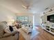 Cozy living room featuring wood floors, comfortable seating, and natural light at 8130 Bugle Ct # 3, Port Richey, FL 34668