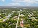 Aerial view of a fenced-in backyard with a gazebo, trampoline, shed, and a fire pit in a private yard at 8324 Nightingale Rd, Weeki Wachee, FL 34613