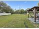 This fenced backyard features a fire pit and gazebo with comfortable seating at 8324 Nightingale Rd, Weeki Wachee, FL 34613