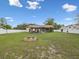 Expansive backyard with a fire pit, gazebo seating area, and full privacy fence, perfect for outdoor entertaining at 8324 Nightingale Rd, Weeki Wachee, FL 34613