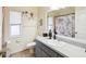 Clean bathroom featuring a vanity with storage, a decorative shower curtain, and great natural light at 8324 Nightingale Rd, Weeki Wachee, FL 34613