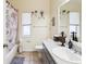Well-maintained bathroom with a shower-tub combo, decorative accents, and a functional vanity at 8324 Nightingale Rd, Weeki Wachee, FL 34613