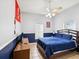 This is a lovely bedroom with blue accent and a ceiling fan at 8324 Nightingale Rd, Weeki Wachee, FL 34613