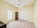 Bright bedroom with a ceiling fan, closet space, and tiled flooring for easy maintenance at 8324 Nightingale Rd, Weeki Wachee, FL 34613