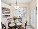 Bright dining area featuring a decorative niche, a stylish light fixture and natural light streaming through a window at 8324 Nightingale Rd, Weeki Wachee, FL 34613