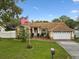 Charming single Gathering home with a manicured lawn, mature landscaping, and a two-car garage at 8324 Nightingale Rd, Weeki Wachee, FL 34613