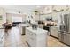 Open kitchen overlooking living area with stainless appliances and kitchen island at 8324 Nightingale Rd, Weeki Wachee, FL 34613