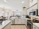 Open kitchen overlooking dining and living areas with stainless appliances and breakfast bar at 8324 Nightingale Rd, Weeki Wachee, FL 34613
