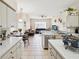 Open kitchen overlooking dining and living areas featuring breakfast bar and white appliances at 8324 Nightingale Rd, Weeki Wachee, FL 34613