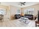Spacious living room featuring leather sofas, tiled floors, and an abundance of natural light at 8324 Nightingale Rd, Weeki Wachee, FL 34613
