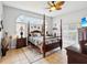 Spacious main bedroom with en-suite bathroom, decorative ceiling fan and sliding glass doors to screened lanai at 8324 Nightingale Rd, Weeki Wachee, FL 34613