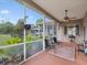 This covered and screened patio has seating and a view of the large yard at 8324 Nightingale Rd, Weeki Wachee, FL 34613