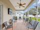This patio has multiple chairs for seating and has screens to keep out bugs at 8324 Nightingale Rd, Weeki Wachee, FL 34613