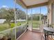 This patio has outdoor seating, screened enclosure, and a view of the large back yard at 8324 Nightingale Rd, Weeki Wachee, FL 34613