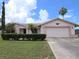 Charming single-story home features a well-manicured lawn, complemented by mature trees and shrubs for enhanced curb appeal at 9056 Horizon Dr, Spring Hill, FL 34608