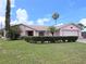 Charming single-story home features a well-manicured lawn, complemented by mature trees and shrubs for enhanced curb appeal at 9056 Horizon Dr, Spring Hill, FL 34608