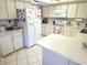 Bright kitchen with ample cabinet and counter space, updated appliances, and tiled floors at 9056 Horizon Dr, Spring Hill, FL 34608