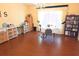 Bright living room with wood floors, large windows, and comfortable furniture, perfect for relaxing and entertaining at 9056 Horizon Dr, Spring Hill, FL 34608