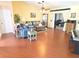 Bright living room features wood floors, vaulted ceiling and sliding doors leading to outdoor space at 9056 Horizon Dr, Spring Hill, FL 34608