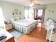 Comfortable main bedroom featuring a ceiling fan, nice natural light, and access to a private lanai at 9056 Horizon Dr, Spring Hill, FL 34608