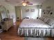 Spacious main bedroom with ceiling fan, wood flooring, and a dresser, providing ample storage space at 9056 Horizon Dr, Spring Hill, FL 34608