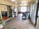 Enclosed sun room with herringbone tile flooring, ceiling fans, and natural light at 9056 Horizon Dr, Spring Hill, FL 34608