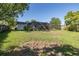 Spacious backyard with lush green grass, bordered by trees, offering a large outdoor space for activities and relaxation at 9195 Bay Dr, Spring Hill, FL 34608