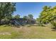 A serene backyard showcasing a screened pool and ample green space at 9195 Bay Dr, Spring Hill, FL 34608