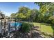 This backyard features a screened-in pool, complete with a well-maintained patio and a lush, green lawn for outdoor enjoyment at 9195 Bay Dr, Spring Hill, FL 34608