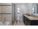 Well-lit bathroom features a double vanity with granite countertops, tiled shower and a separate toilet area for added convenience at 9195 Bay Dr, Spring Hill, FL 34608