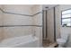 Bathroom featuring shower with pebble floor, soaking tub, and tiled walls at 9195 Bay Dr, Spring Hill, FL 34608