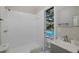 Bathroom offers access to a screen enclosed pool and foliage at 9195 Bay Dr, Spring Hill, FL 34608