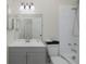 Well lit bathroom with large mirror, and shower/tub combo with white tile at 9195 Bay Dr, Spring Hill, FL 34608