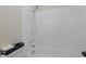 White bathtub and shower combo with handheld shower head and toiletry items at 9195 Bay Dr, Spring Hill, FL 34608