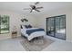 Bright bedroom with slider that leads to porch, white tile floor, ceiling fan and neutral walls create a peaceful, inviting space at 9195 Bay Dr, Spring Hill, FL 34608