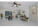 Cozy dining area with seating for four, next to a kitchen with granite counters at 9195 Bay Dr, Spring Hill, FL 34608