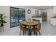 Dining area next to kitchen and pool with round table and seating for four at 9195 Bay Dr, Spring Hill, FL 34608