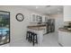 Bright kitchen with granite countertops, stainless steel appliances, tile floors and bar seating at 9195 Bay Dr, Spring Hill, FL 34608