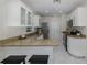 Bright kitchen features granite countertops, stainless steel appliances, and breakfast bar seating at 9195 Bay Dr, Spring Hill, FL 34608