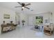 Bright living room with tile flooring, ceiling fan, and a view to the front yard at 9195 Bay Dr, Spring Hill, FL 34608