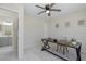 Bright office with ceiling fan, desk with chair and doorway to a bathroom at 9195 Bay Dr, Spring Hill, FL 34608